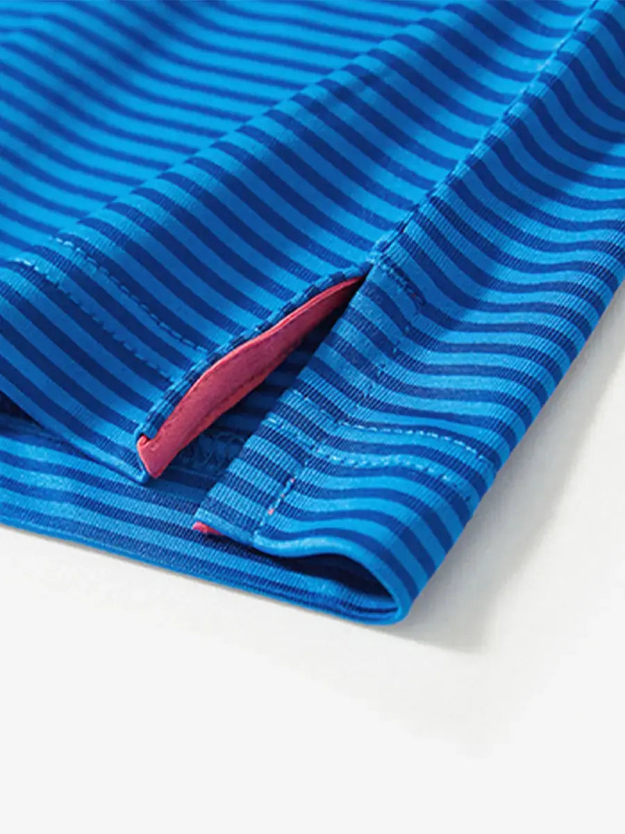 Close-up of hem slit on COBALT STRIPE polo, functional detail meets sharp course-ready design