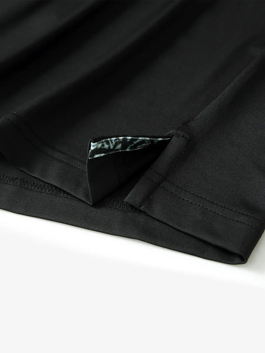 Close-up of side slit hem detail on BLACK Long Sleeve Solid Jersey Polo