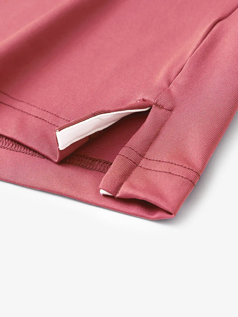 Hem slit detail of CRANBERRY Moisture Wicking Color Block Polo Shirt highlighting stitching and finish.