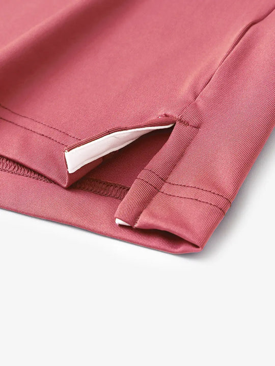 Hem slit detail of CRANBERRY Moisture Wicking Color Block Polo Shirt highlighting stitching and finish.