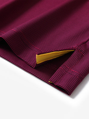 Hem detail of Long sleeve pinstripe jersey polo with neat finish in maroon stripe