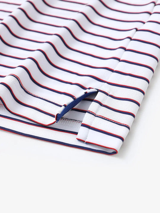 Hem slit detail of WHITE/NAVY STRIPE Youth Performance Golf Polo highlighting stitching and finish.
