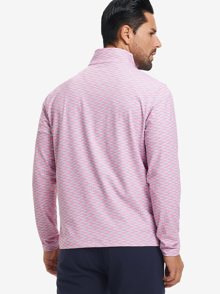 Back upper body angle of the pink small fish full print quarter zip pullover, model turns head slightly.
