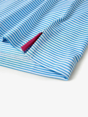 Detailed view of side hem slit on Cooling Stripe Golf Shirt in SKY BLUE STRIPE, showing comfort and design