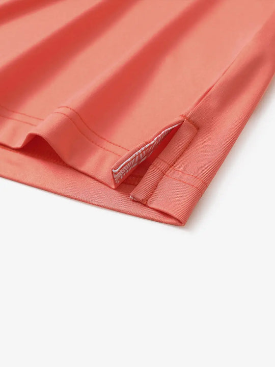 Close-up of side slit detail on the Melon Everyday Classic Solid Polo hem