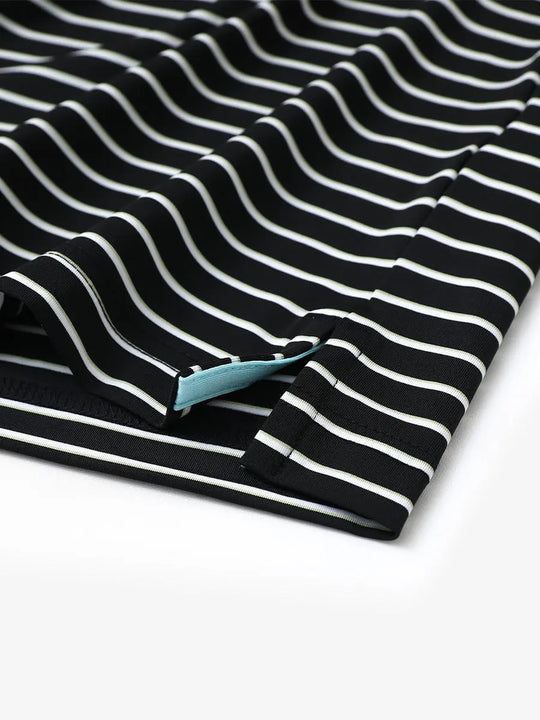 Close-up of side slit hem on BLACK/WHITE STRIPE Polo with crisp finishing
