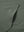 Close-up of single pocket detail on youth long sleeve hoodied with kangaroo pocket in olive green, showing stitching.
