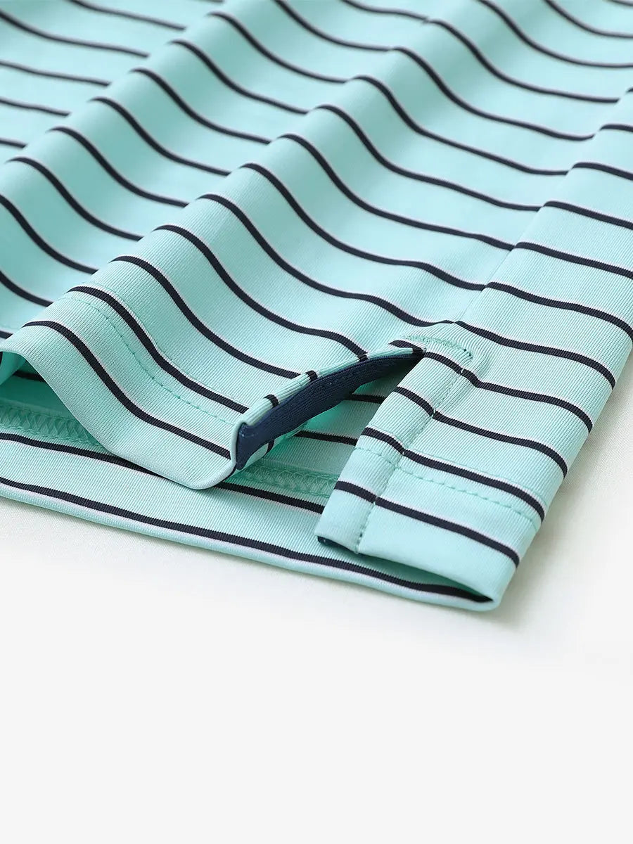 Hem slit detail of TURQUOISE/NAVY STRIPE Youth Performance Golf Polo highlighting stitching and finish.
