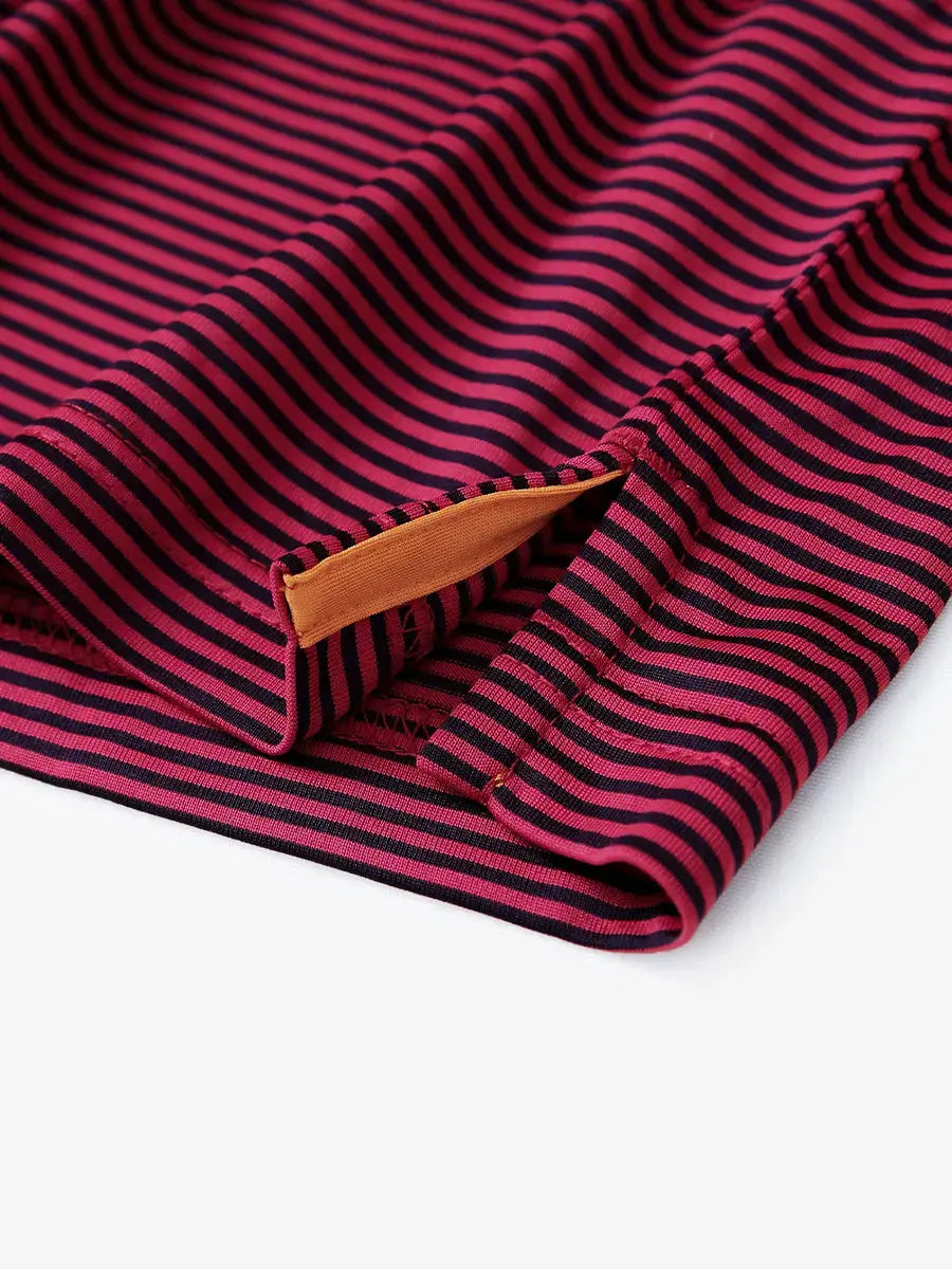 Hem slit detail of RED STRIPE polo shirt, functional cut in a bold golf-ready design