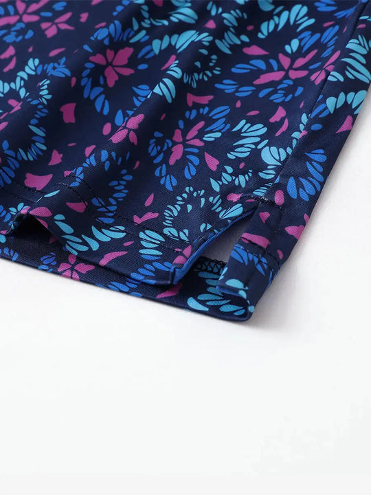 Detailed close-up of side hem slit on NAVY COLORFUL FLOWER Performance Print Boys Golf Polo for comfort