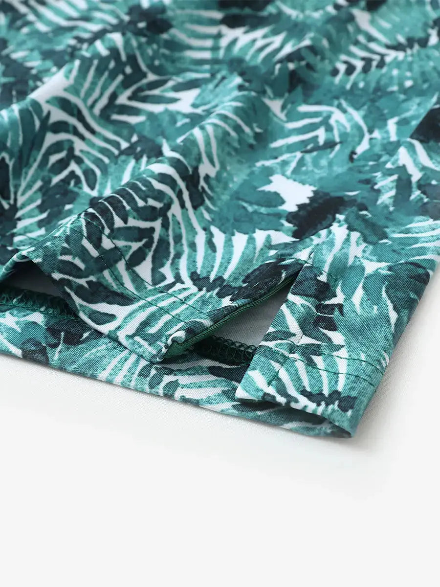 Hem slit detail of MAELREG Performance Jersey Print Polo in Dark Green Leaf – comfort & movement