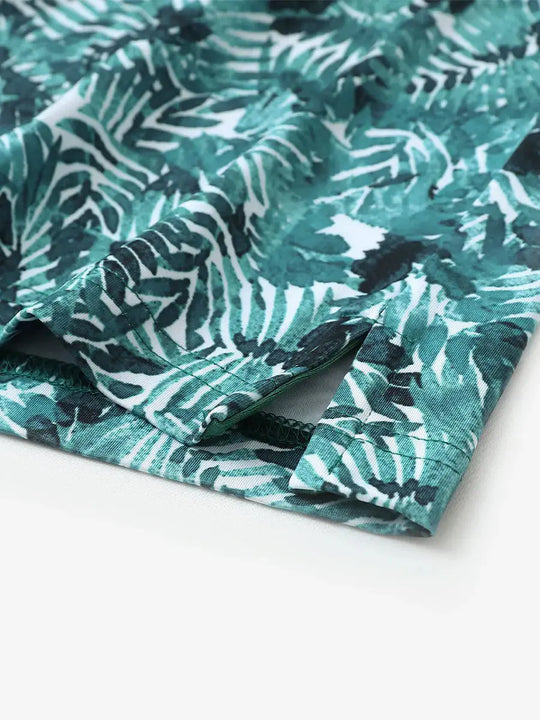 Hem slit detail of MAELREG Performance Jersey Print Polo in Dark Green Leaf – comfort & movement