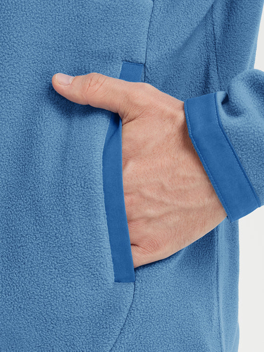 Hand in pocket detail of the Misty Blue Quarter Zip Polar Fleece Sweatshirt, soft fleece fabric.