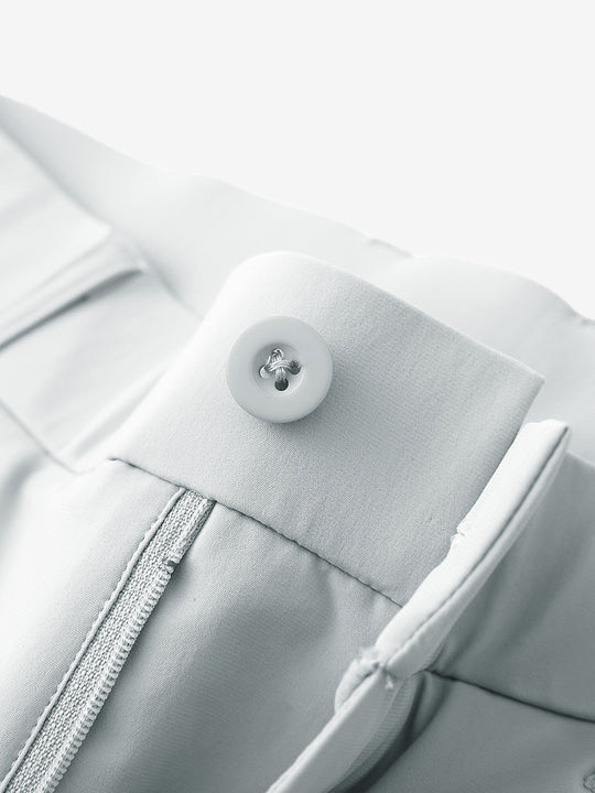 Waist detail of quick dry casual dress pants in glacier grey, featuring button and zipper design.
