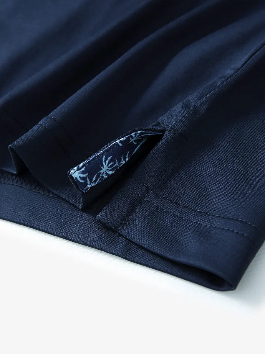 Close-up of side slit hem detail on NAVY Long Sleeve Solid Jersey Polo
