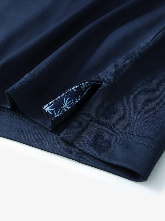Close-up of side slit hem detail on NAVY Long Sleeve Solid Jersey Polo