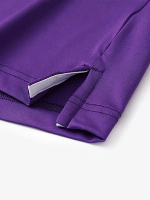 Hem slit detail of PURPLE Moisture Wicking Color Block Polo Shirt highlighting stitching and finish.