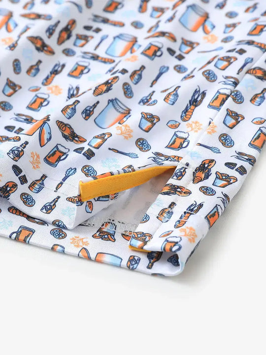 Detailed close-up of side hem slit on WHITE ORANGE PICNIC Performance Print Boys Golf Polo for comfort