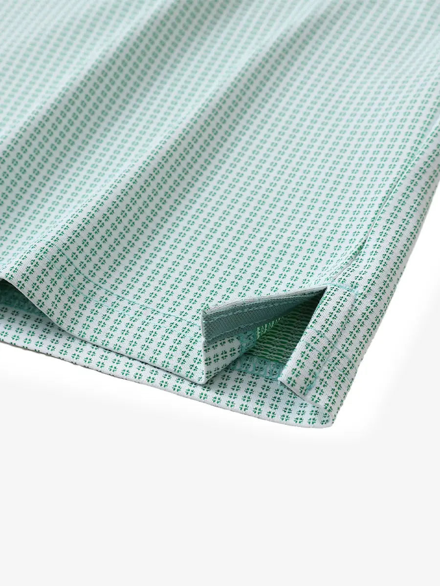 Close-up of hem slit detail on EMERALD Elegant Performance Jacquard Polo