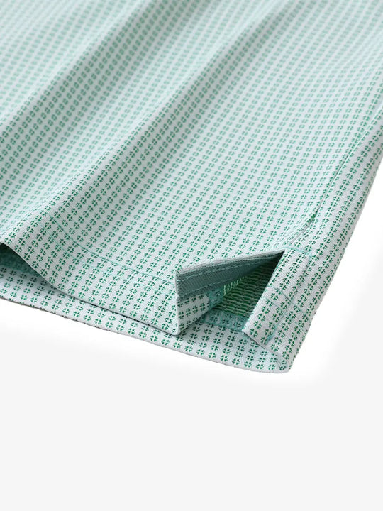 Close-up of hem slit detail on EMERALD Elegant Performance Jacquard Polo