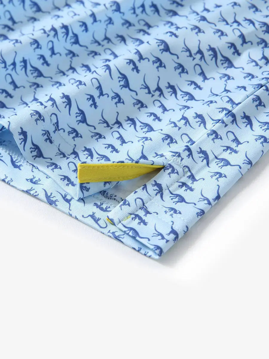 Detailed close-up of side hem slit on BLUE DINOSAUR Performance Print Boys Golf Polo for comfort