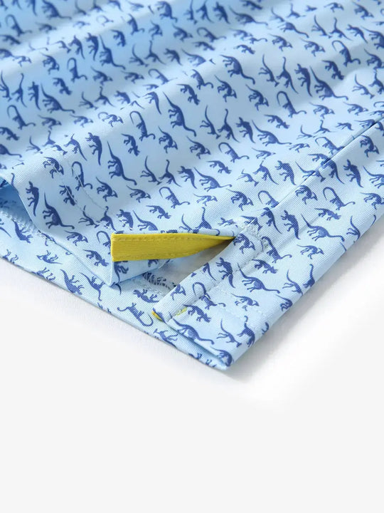 Detailed close-up of side hem slit on BLUE DINOSAUR Performance Print Boys Golf Polo for comfort