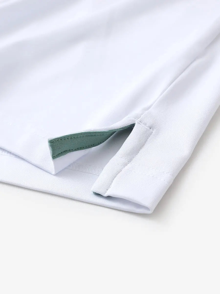 Hem slit detail of WHITE Moisture Wicking Color Block Polo Shirt highlighting stitching and finish.