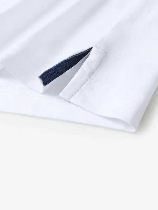 Close-up of side slit detail on the White Everyday Classic Solid Polo hem