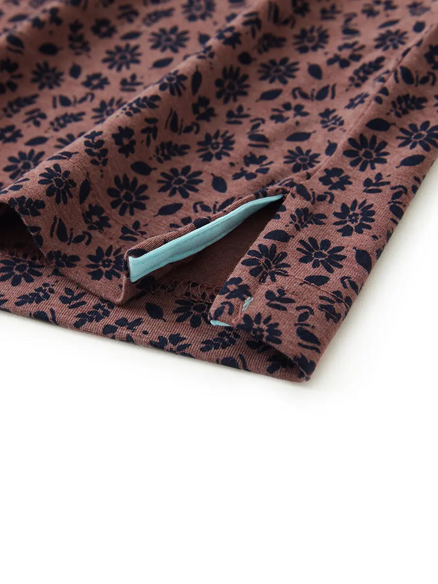 Hem slit detail of WINE RED FLOWER Popular Heather Print Polo highlighting stitching and finish