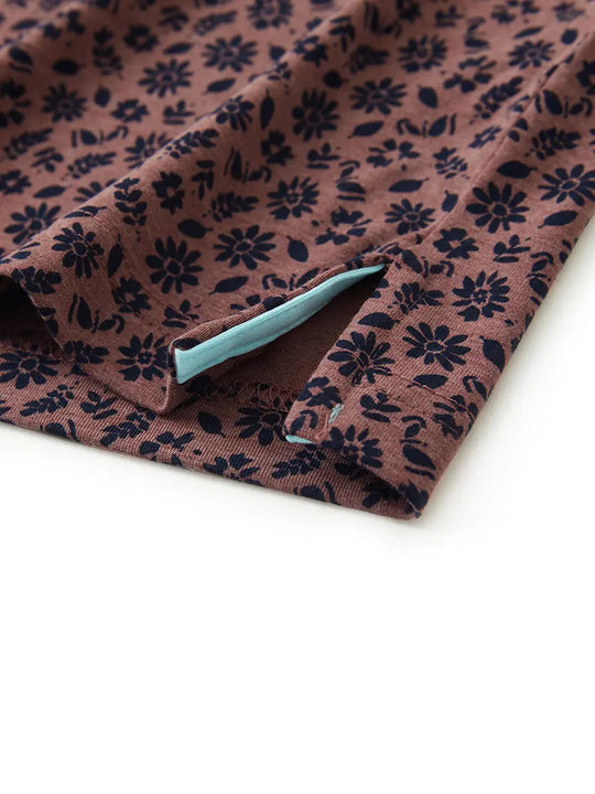 Hem slit detail of WINE RED FLOWER Popular Heather Print Polo highlighting stitching and finish