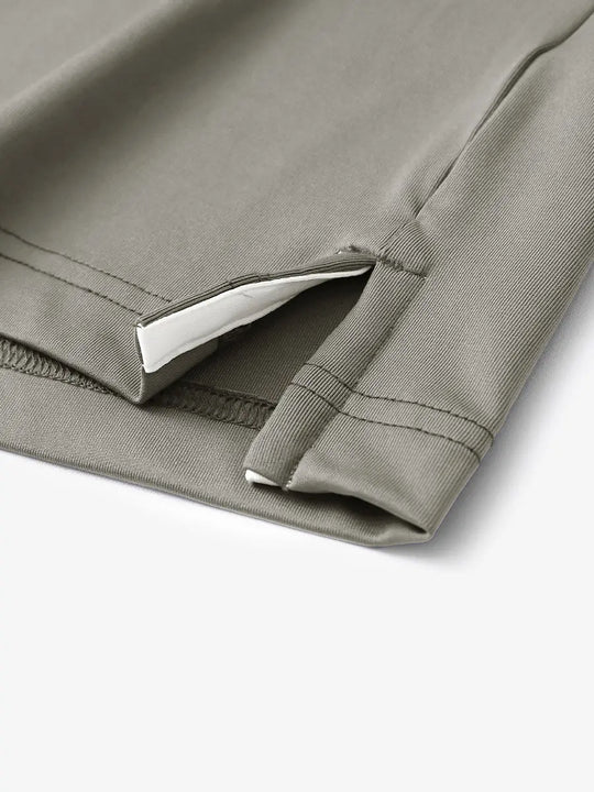 Hem slit detail of DARK KHAKI Moisture Wicking Color Block Polo Shirt highlighting stitching and finish.
