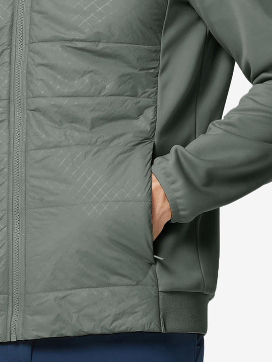 Hand in single pocket detail of the Agave Green Golf Fleece Winter Jacket, soft thermal material.