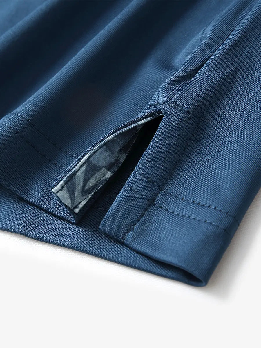 Close-up of side slit hem detail on BLUE Long Sleeve Solid Jersey Polo