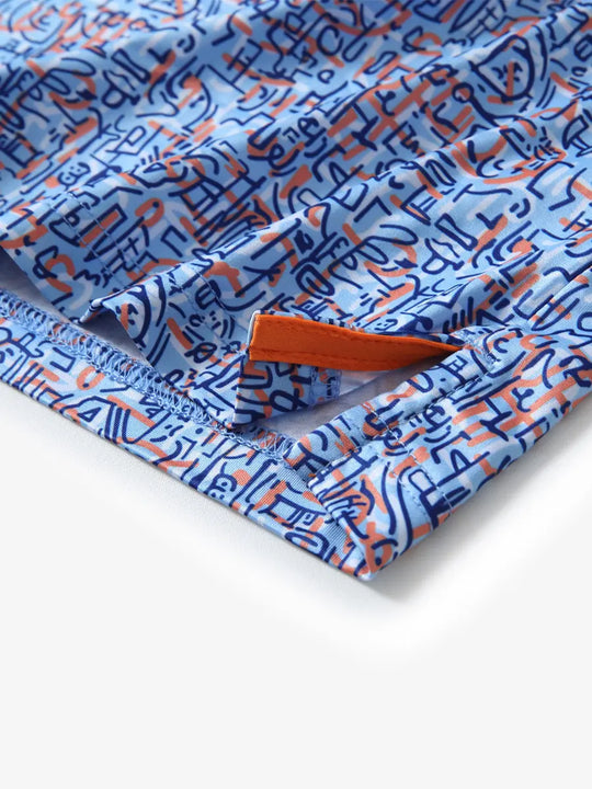 Detail view of the blue doodles pattern polo, highlighting the neat hem opening and fine stitching for comfort.