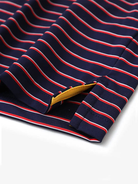 Detail shot of side slit hem on NAVY/RED STRIPE Polo with clean stripe alignment