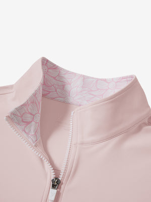 Zipper and inner pattern detail of the print collar quarter zip golf vest in light pink, highlighting design.