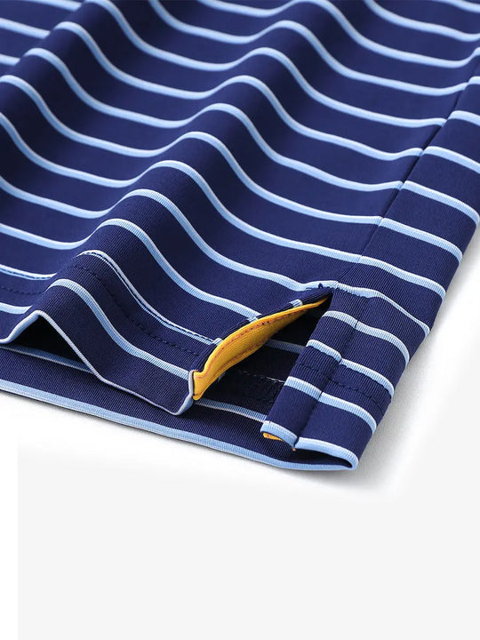 Hem slit detail of NAVY/SKY BLUE STRIPE Youth Performance Golf Polo highlighting stitching and finish.