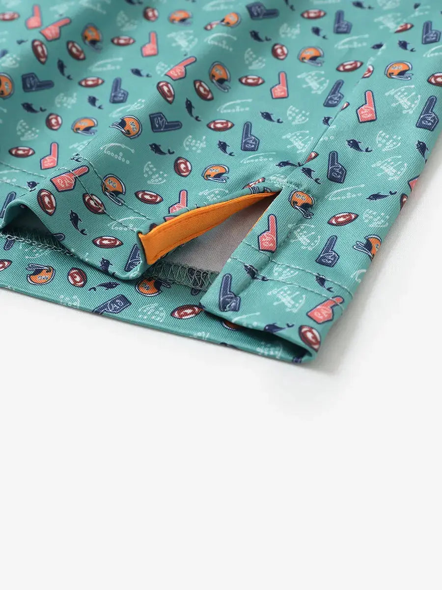 Detailed close-up of side hem slit on GREEN RUGBY Performance Print Boys Golf Polo for comfort