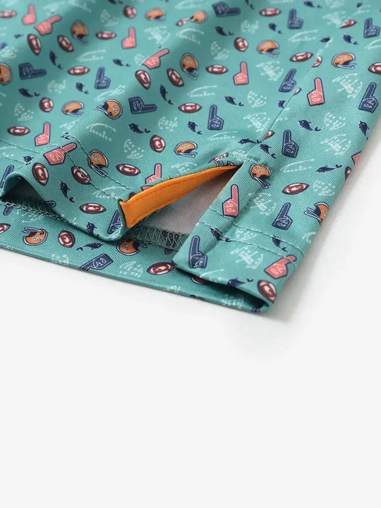 Detailed close-up of side hem slit on GREEN RUGBY Performance Print Boys Golf Polo for comfort