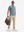 Full-body shot of model with a briefcase in blue flower breathable jacquard pattern 3-button golf polo