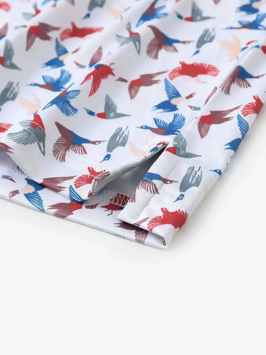 Detailed close-up of side hem slit on COLORFUL WILD GOOSE Performance Print Boys Golf Polo for comfort