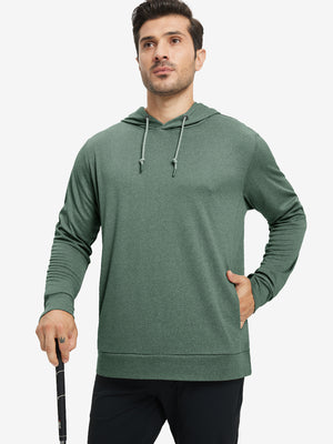 Model with one hand in pocket, wearing classic heather pullover hoodie in dark green melange, relaxed look.