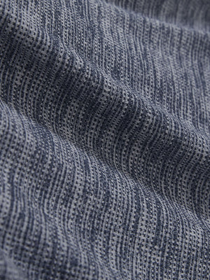 Close-up texture of misty blue white grid featherweight midlayer quarter zip pullover fabric showing detailed lightweight material and weave.