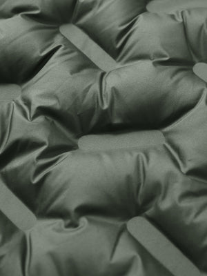 Fabric close-up of boys windproof puffer jacket with pockets, highlighting texture and finish in army green.