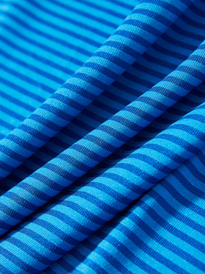 Close-up of cobalt stripe performance cooling polo - youth fabric texture.