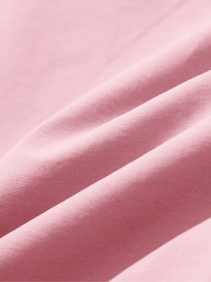 Close-up of pink boys lightweight dry fit flat front golf shorts fabric texture.