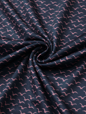 Close-up of navy pink seagull performance print boys golf polo fabric showing moisture-wicking texture and vibrant pattern.