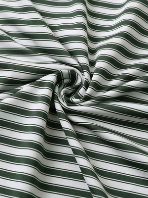 Close-up of olive green white yarn dyed stripe polo fabric showing distinct woven stripes and textured surface.