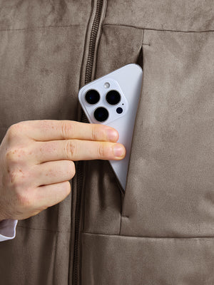 Close-up view of gray brown classic micro suede leather puffer vest exterior center pocket detail