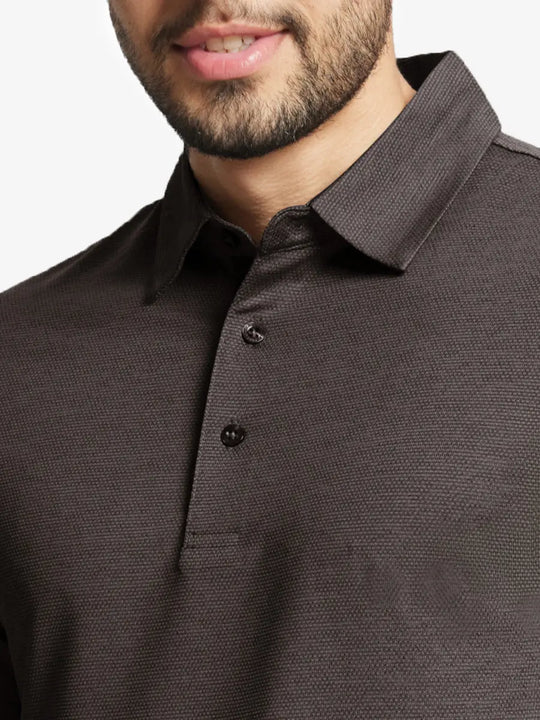 Model front close-up from nose to chest wearing Ventilated Heather Jacquard Polo in DARK BROWN HEATHER